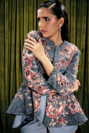 Embellished peplum jacket paired with sculpted satin skorts